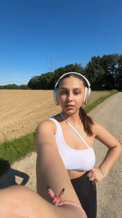 Woman records selfie videos on rural path in Viersen