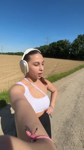 Woman records selfie videos on rural path in Viersen
