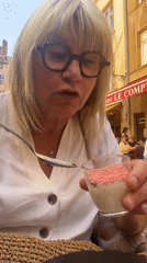 Woman enjoys dessert sampler at outdoor café in Lyon