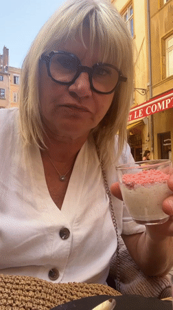 Woman enjoys dessert sampler at outdoor café in Lyon