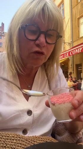 Woman enjoys dessert sampler at outdoor café in Lyon