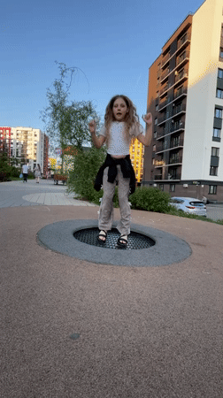Child plays in Pervomaysky neighborhood amid spring blooms