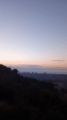 Barcelona skyline at dusk, sea views and ornate spire