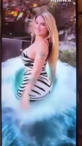 The video begins with a woman in a black and white striped bikini standing in a pool of water with a swirling vortex effect around her. The next shot shows an underwater view of what appears to be a bright, abstract object with green and orange hues. The video concludes with a woman with long blonde hair and a shimmering mermaid tail swimming underwater, with the tail exhibiting a gradient of green and yellow. The environment is aquatic with blurred blue and white elements suggesting water and light.