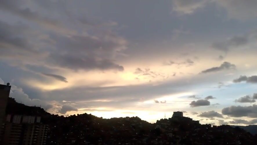 Caracas at dusk: hillside neighborhoods and a city settling into night