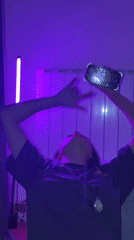 Purple-lit gathering captured on phones in Belgrade room