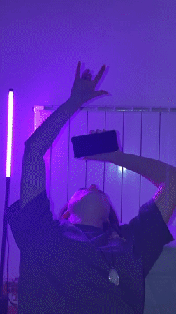 Purple-lit gathering captured on phones in Belgrade room