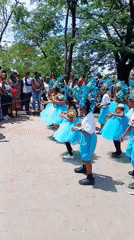 Young dancers perform in turquoise costumes at Abuja park