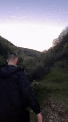 Two men walk through field near Chintulovo, Bulgaria