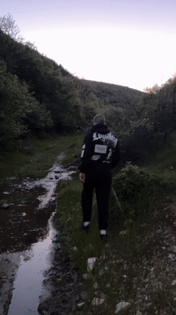 Two men walk through field near Chintulovo, Bulgaria