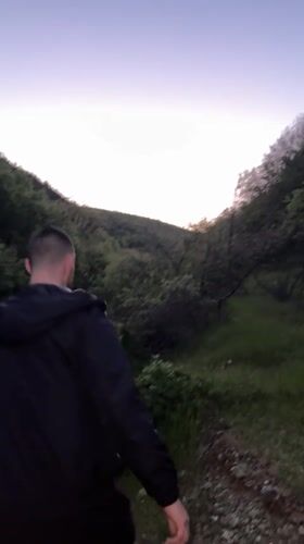 Two men walk through field near Chintulovo, Bulgaria