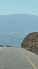 Driving down toward the Dead Sea through arid desert terrain