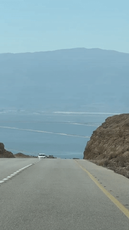 Driving down toward the Dead Sea through arid desert terrain