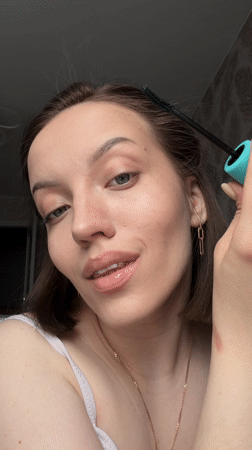 Woman completes morning beauty routine in Reshetnikovo, Russia