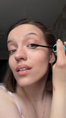 Woman completes morning beauty routine in Reshetnikovo, Russia