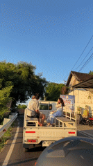 Passengers ride in pickup truck bed in Abang, Indonesia
