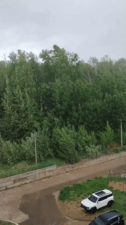 Woman documents stormy day indoors in Noviy, Russia