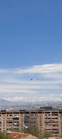 Four helicopters fly in formation over Yerevan skyline