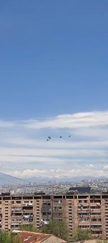Four helicopters fly in formation over Yerevan skyline