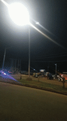 Nighttime street life along a commercial strip in Jos, Nigeria