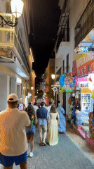 Evening strolls captured across illuminated Benidorm promenade and streets