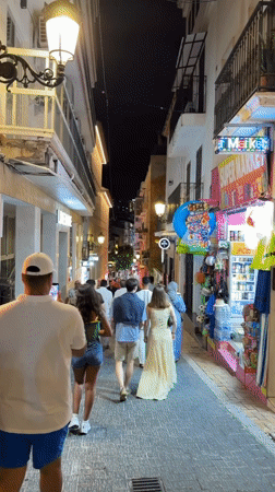 Evening strolls captured across illuminated Benidorm promenade and streets