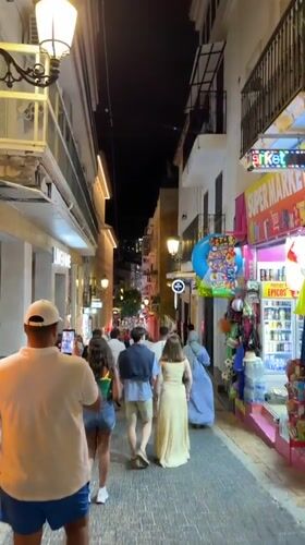 Evening strolls captured across illuminated Benidorm promenade and streets