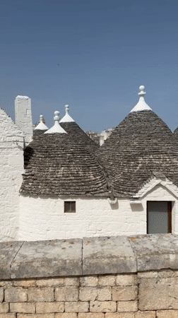 Exploring Alberobello's trulli district, rooftops and street life