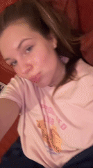 Woman rests on couch in novelty shirt, Belgrade area