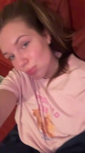 Woman rests on couch in novelty shirt, Belgrade area