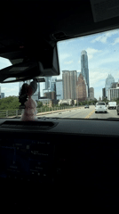Driver captures Austin skyline view while approaching city