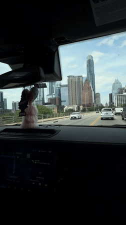 Driver captures Austin skyline view while approaching city