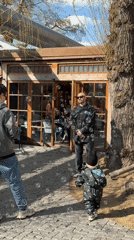 Man blows bubbles for toddler outside Moscow building