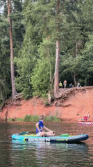 Paddleboarding near red cliffs and a historic manor in Leningrad Oblast