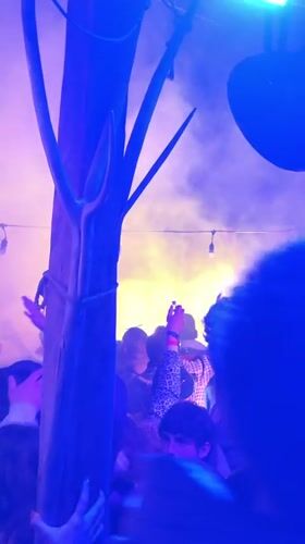 Nighttime outdoor festival with dancing crowds in Maglic, Serbia