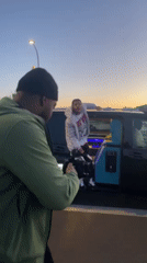Man filmed posing by van near Eiffel Tower at sunset