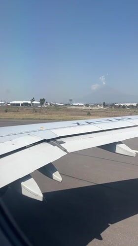 Passenger films airplane wing view at Mexican airport