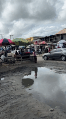 Lagos street market bustles despite muddy conditions