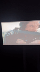 TV screen shows film scene in Braunstone Town