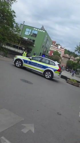 Police car parked outside market in Blagoevgrad, Bulgaria