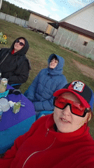 Three women gather at outdoor table in Markovo