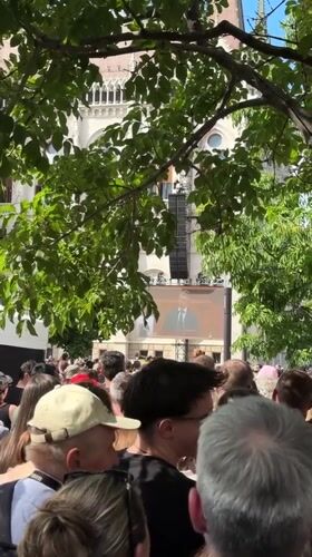 Large crowd gathers in Budapest square watching speech