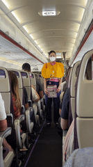 Flight attendant observed during routine service on Thai commercial flight