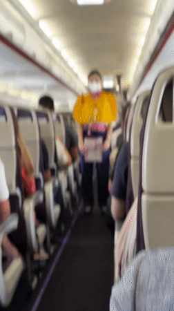 Flight attendant observed during routine service on Thai commercial flight
