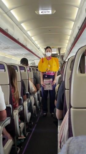 Flight attendant observed during routine service on Thai commercial flight