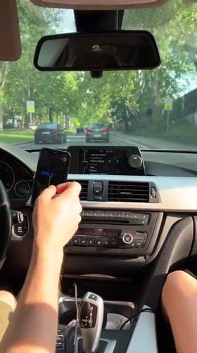 Driver uses smartphone while driving BMW in Belgrade suburb