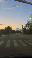 Evening traffic flows through Podgorica intersection at dusk