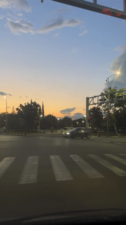 Evening traffic flows through Podgorica intersection at dusk