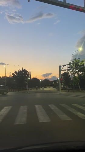Evening traffic flows through Podgorica intersection at dusk