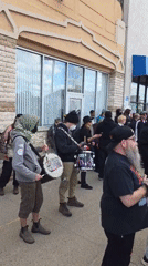 Street protest with drums, signs outside Hamtramck mosque